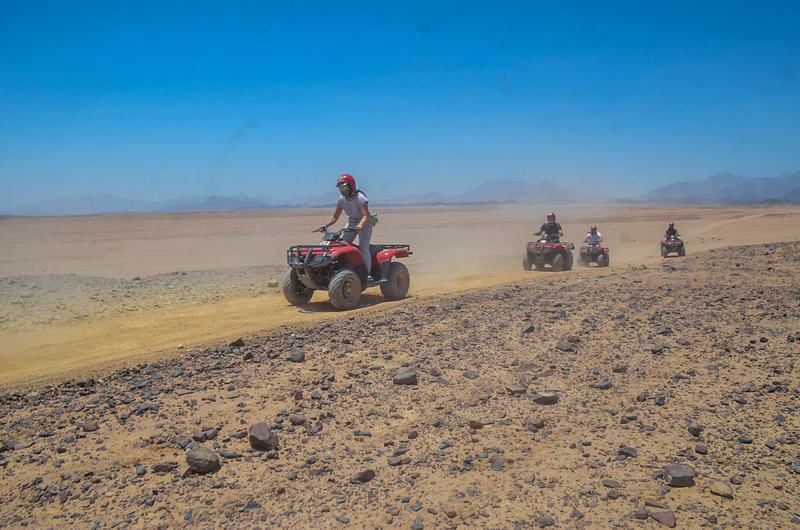 Quad convoy kicking up desert dust